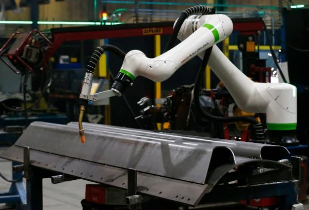 A robotic welder are in the Caterpillar plant